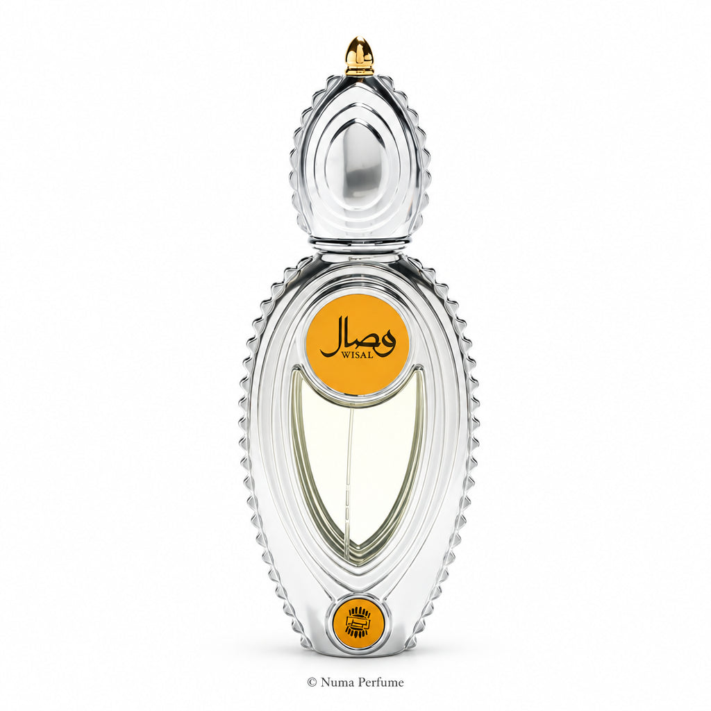A silver metallic perfume bottle with a decorative textured border, featuring two circular gold labels with black Arabic calligraphy and the brand name 'WISAL'.