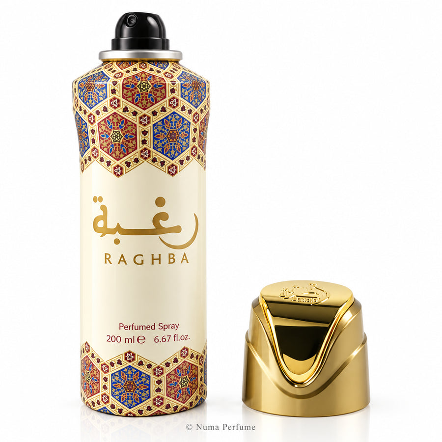 A 200 ml can of Raghba Perfumed Spray with a black spray nozzle, featuring a cream-colored body with gold Arabic calligraphy and a blue and gold geometric pattern near the top and bottom. The metallic gold cap is shown standing next to the can on a plain white background.