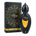 A bottle of Ajmal Wisal Layl Eau de Parfum next to its decorative packaging box. The bottle and box are dark black with intricate gold patterns and a prominent gold heart-shaped window on the bottle.