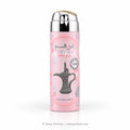 A pink cylindrical perfume spray bottle with a reflective silver cap, featuring a traditional Arabic coffee pot illustration and the brand name 'DIRHAM' on a clean white background.