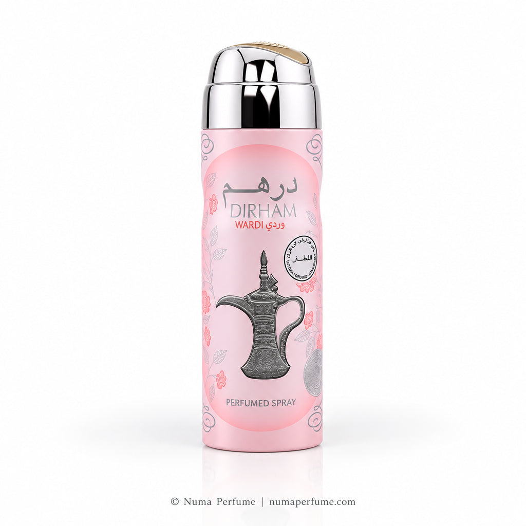 A pink cylindrical perfume spray bottle with a reflective silver cap, featuring a traditional Arabic coffee pot illustration and the brand name 'DIRHAM' on a clean white background.