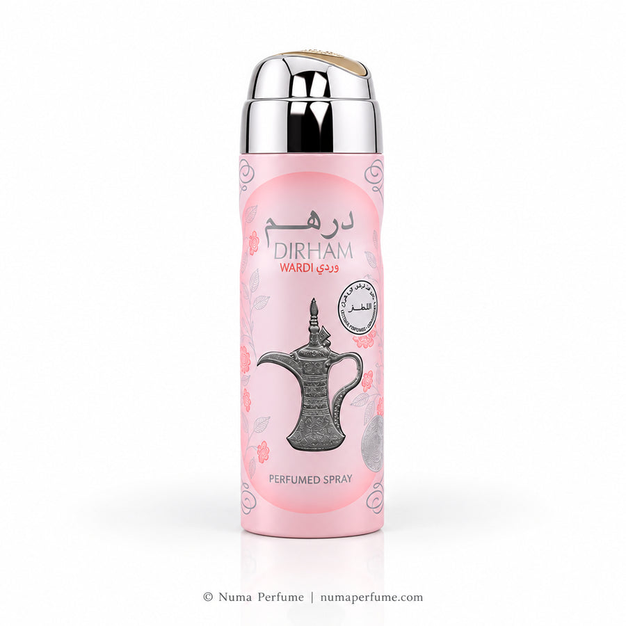 A pink cylindrical perfume spray bottle with a reflective silver cap, featuring a traditional Arabic coffee pot illustration and the brand name 'DIRHAM' on a clean white background.