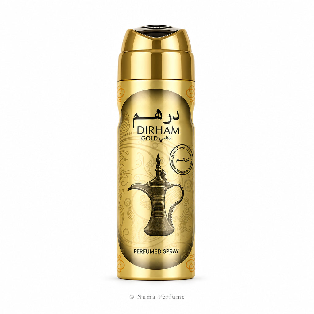 A gold cylindrical perfume spray bottle with a metallic cap, featuring the brand name 'DIRHAM' and Arabic text on a light beige patterned label, set against a plain white background.