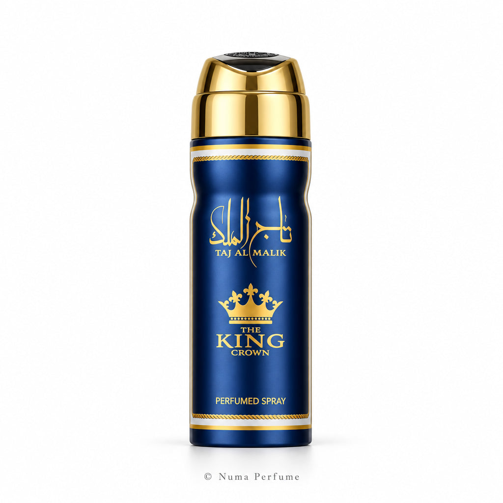 A cylindrical perfume spray bottle with a metallic gold cap and a deep blue body, featuring gold lettering that reads 'Taj Al Malik' and 'The King Crown' on a light gray background.