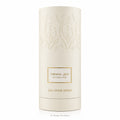 A tall, cylindrical off-white cardboard packaging container for Takhal All Over Spray, featuring embossed floral patterns and a central gold-bordered label with Arabic and English text.