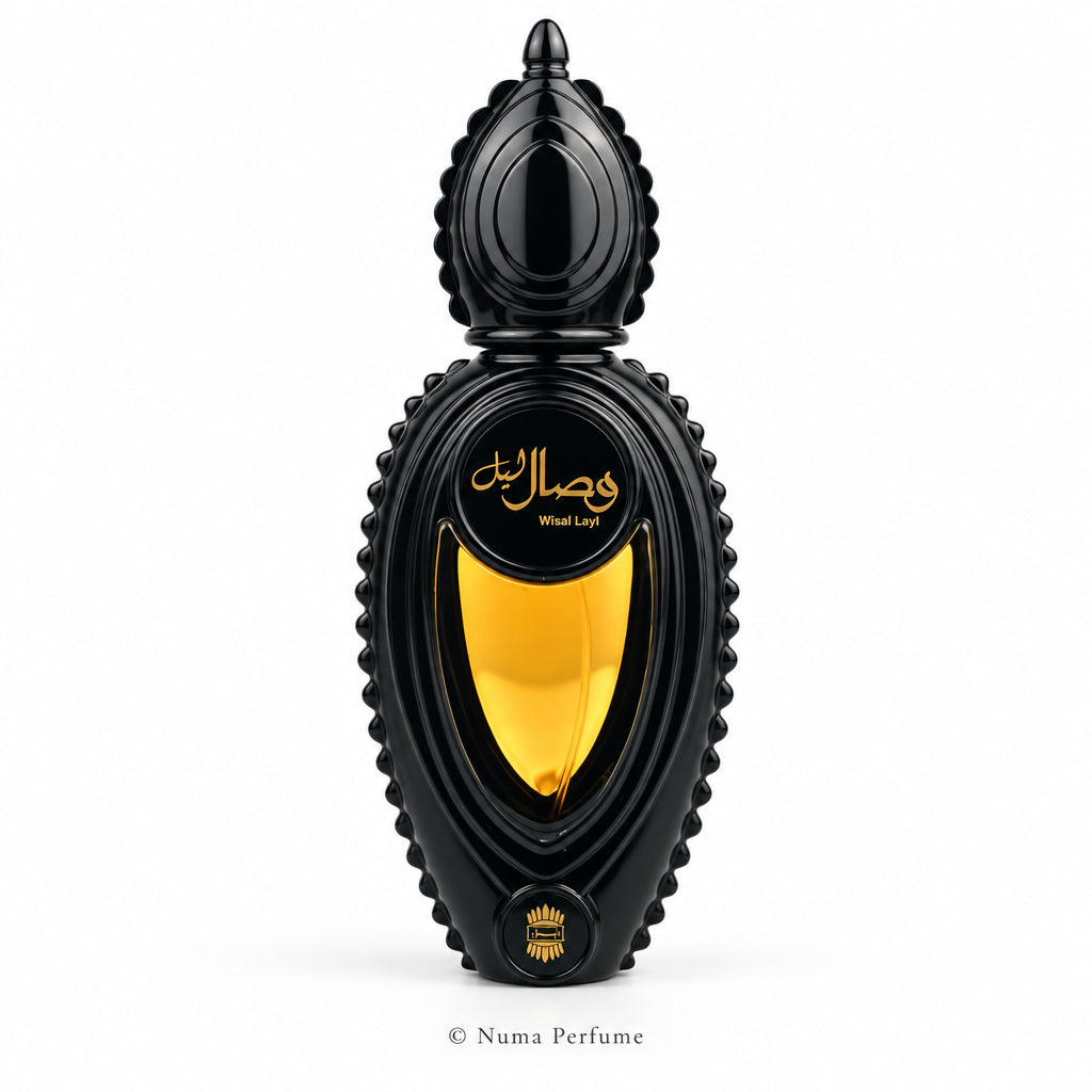 A black perfume bottle with a sculpted, bulbous cap and base, featuring a large gold and yellow gradient center panel with Arabic script and the text 'Wheat Layt' on a white background.