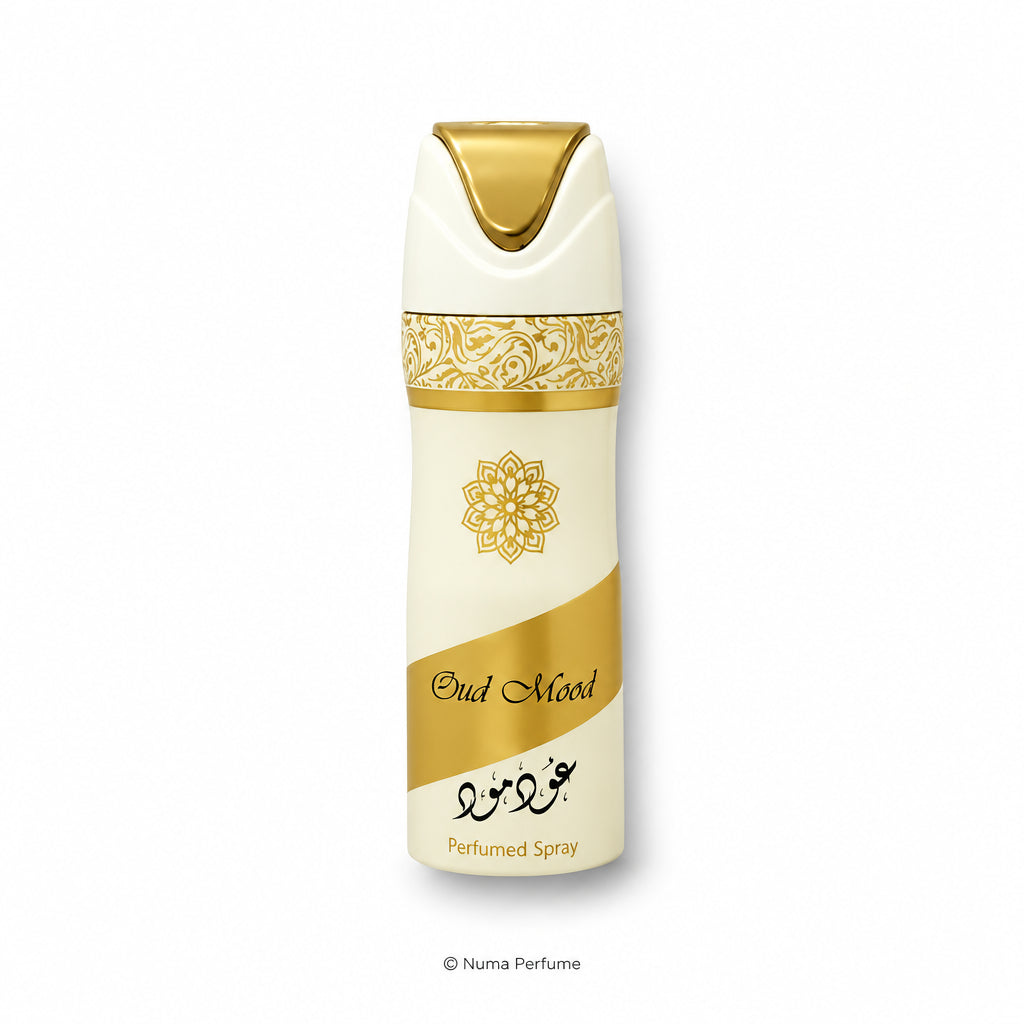 A perfume spray bottle labeled 'Bud Mood' with a cream and gold design, featuring a gold ornamental pattern and a gold cap, set against a plain white background.