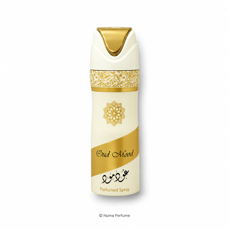 A perfume spray bottle labeled 'Bud Mood' with a cream and gold design, featuring a gold ornamental pattern and a gold cap, set against a plain white background.