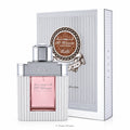 Perfume bottle with pink liquid and silver cap next to its packaging on a white background