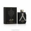 Shaghaf Man Eau de Parfum bottle and its black packaging box, featuring a faceted black design with a metallic silver 'A' motif and gold lettering.